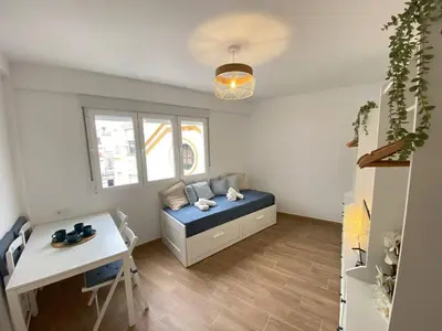 a room with a bed and a desk and a table at Apartamento Trascuesta, PLENO CENTRO in Sanlúcar de Barrameda
