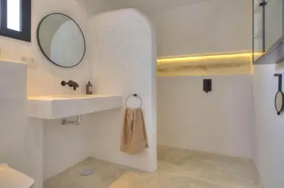 a bathroom with a sink and a mirror at Villa Mas Tranquila - A stylish villa with pool 150 m from the beach in Conil de la Frontera