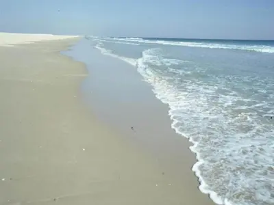 a beach with the ocean and the shoreline at Beautiful apartment in San Fernando near lake in San Fernando