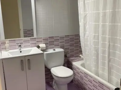 a bathroom with a toilet and a sink and a tub at Beautiful apartment in San Fernando near lake in San Fernando