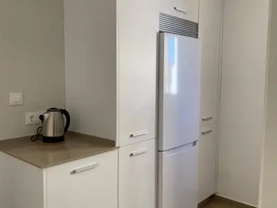 a kitchen with white cabinets and a refrigerator at Beautiful apartment in San Fernando near lake in San Fernando
