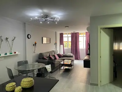 a living room with a couch and a table at Piso Centro La Morena, Climatizado, Wifi in Sanlúcar de Barrameda