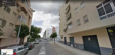 a city street with cars parked on the street at Piso Centro La Morena, Climatizado, Wifi in Sanlúcar de Barrameda