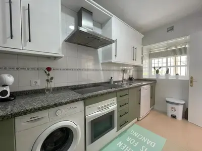 a kitchen with a washer and a sink and a dishwasher at El Sabor del Sur, Apartamentos Living Sur in Sanlúcar de Barrameda