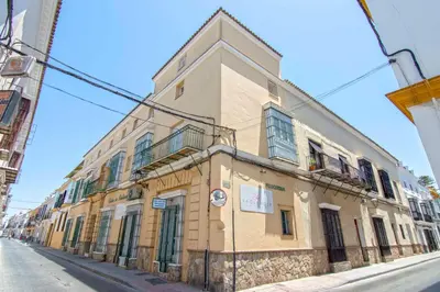 a building on the side of a street at El Sabor del Sur, Apartamentos Living Sur in Sanlúcar de Barrameda