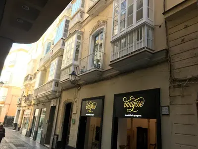 a building with signs on the side of a street at Precioso alojamiento con patio interior in Cádiz