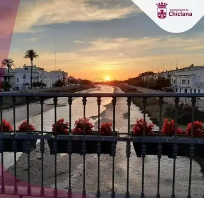 a view of a street with flowers on a fence at El Ancla in Chiclana de la Frontera
