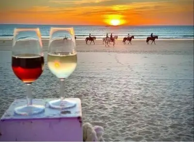 two glasses of wine on the beach at sunset at El Ancla in Chiclana de la Frontera