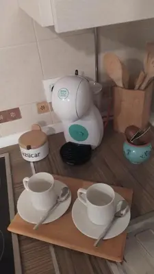 a pretend kitchen with cups and saucers on a table at El Ancla in Chiclana de la Frontera