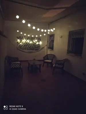 a room with chairs and a table and lights at El Ancla in Chiclana de la Frontera