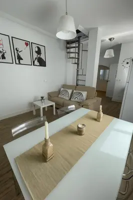 a living room with a couch and a table at Atico duplex con Terraza en pleno centro de Jerez in Jerez de la Frontera