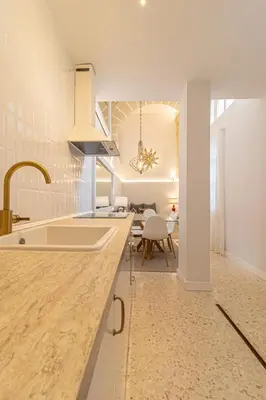 a kitchen with a counter with a sink and a table at La Casa de los Arcos - Casco Histórico - Parking opcional in Jerez de la Frontera