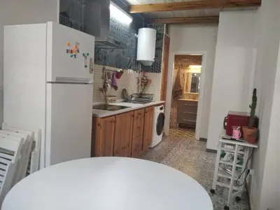 a kitchen with a white refrigerator and a sink at CASITA CÉNTRICA Corro de Bolos in Sanlúcar de Barrameda