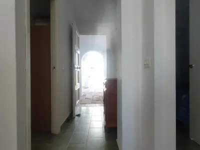 a hallway with an open door to a room with a window at Pinar de Don Jesus Aries in Novo Sancti Petri