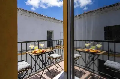 a balcony with two tables with food on it at El Mirador de El Puerto in El Puerto de Santa María
