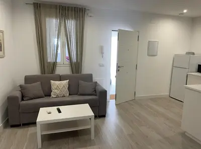 a living room with a couch and a table at El Mirador de El Puerto in El Puerto de Santa María