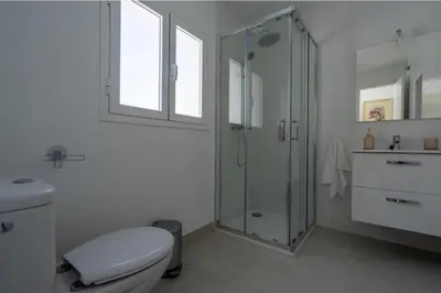 a bathroom with a shower and a toilet and a sink at El Mirador de El Puerto in El Puerto de Santa María