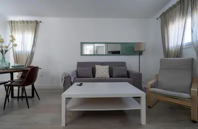 a living room with a couch and a table at El Mirador de El Puerto in El Puerto de Santa María