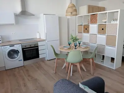 a kitchen and dining room with a table and chairs at Apartamento Mar I in San Fernando