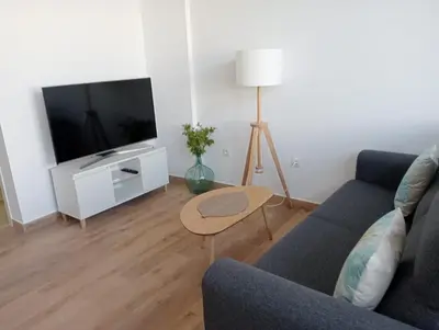 a living room with a couch and a tv at Apartamento Mar I in San Fernando