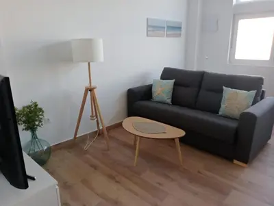 a living room with a couch and a table at Apartamento Mar I in San Fernando