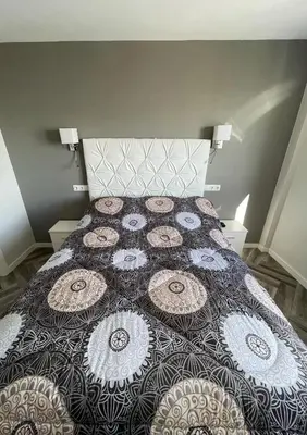 a bedroom with a bed with a quilt on it at Piso playa Maktub in Puerto Real