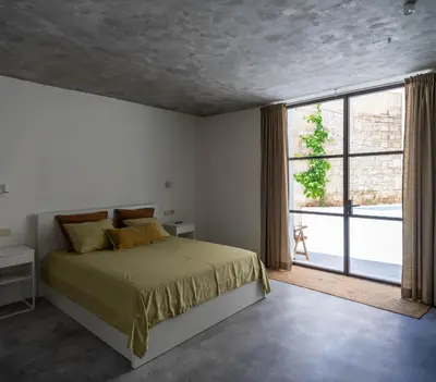 a bedroom with a bed and a large window at La Bodega Flamenca in Jerez de la Frontera