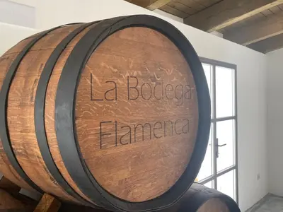 a large wooden barrel with the words la bohemia enigma at La Bodega Flamenca in Jerez de la Frontera
