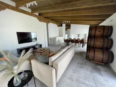 a living room with a couch and wine barrels at La Bodega Flamenca in Jerez de la Frontera