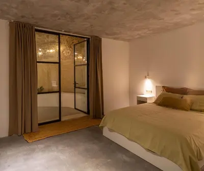 a bedroom with a bed and a large window at La Bodega Flamenca in Jerez de la Frontera