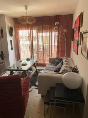 a living room with a couch and a table at Quito in El Puerto de Santa María