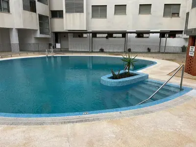 a large swimming pool in the middle of a building at Quito in El Puerto de Santa María