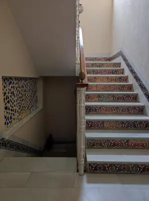 a staircase in a house with a painting on the wall at Casa Hormaza in Chiclana de la Frontera
