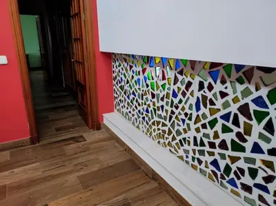a room with a wall with a colorful tile wall at Casa Hormaza in Chiclana de la Frontera