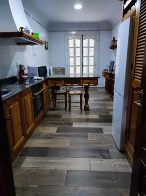 a kitchen with a pool table in the middle of it at Casa Hormaza in Chiclana de la Frontera