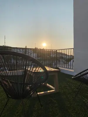 a bench on a balcony with a view of the ocean at CasaElbarranko in Arcos de la Frontera