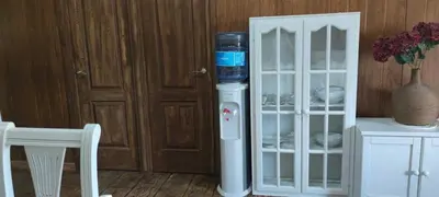 a water cooler sitting next to a white cabinet at Bungalow para quienes buscan tranquilidad in Chiclana de la Frontera