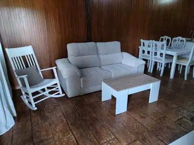 a living room with a couch and two chairs and a table at Bungalow para quienes buscan tranquilidad in Chiclana de la Frontera