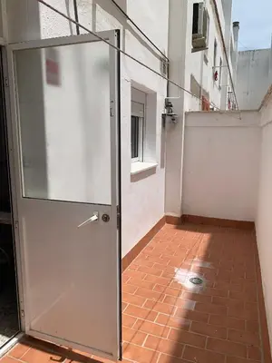 a glass door in a room with a brick floor at Casa Amapola - Costa Bahía de Cádiz in Puerto Real