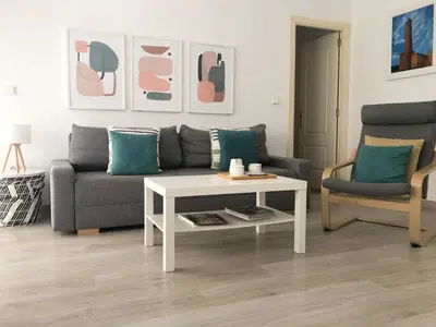 a living room with a couch and a coffee table at Playa Laguna Bajo Parking in Chipiona