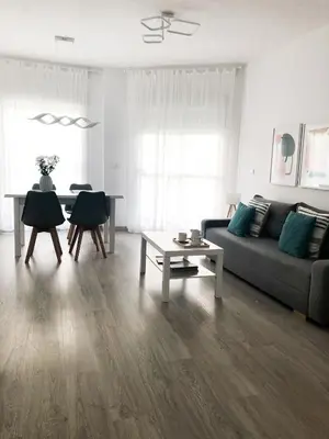 a living room with a couch and a table at Playa Laguna Bajo Parking in Chipiona