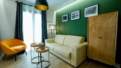 a living room with a couch and a table at Aparthotel Luz de Gades - Suites Spa Gym - Adults Only in Cádiz