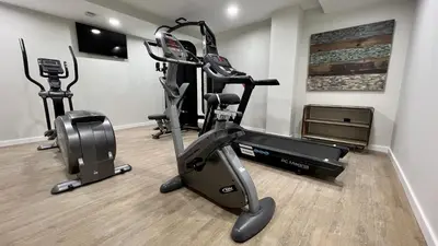a gym with treadmills and exercise bikes in a room at Aparthotel Luz de Gades - Suites Spa Gym - Adults Only in Cádiz