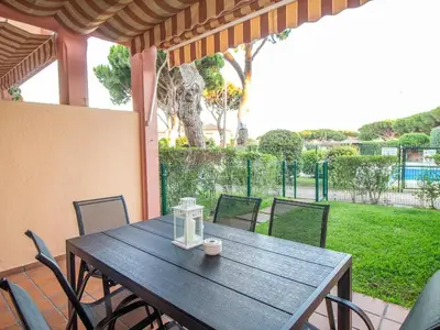 a kitchen with white cabinets and a stainless steel refrigerator at GuestReady - Chiclana Labarrosa in Novo Sancti Petri