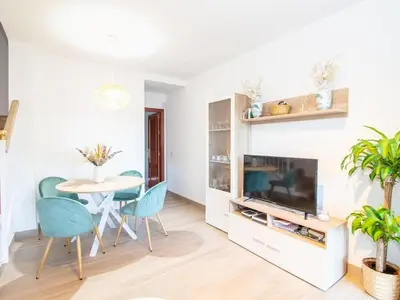 a living room with a couch and a table at GuestReady - Chiclana Labarrosa in Novo Sancti Petri
