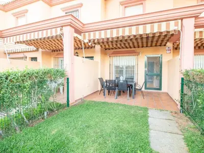 a living room with a table and chairs at GuestReady - Chiclana Labarrosa in Novo Sancti Petri