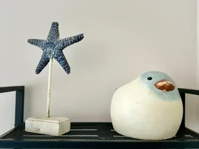 a starfish and a white vase on a shelf at La Casita del Mar in El Puerto de Santa María