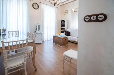 a living room with a table and a dining room at Apartamento Sherezade y la ciudad de Cádiz in Cádiz
