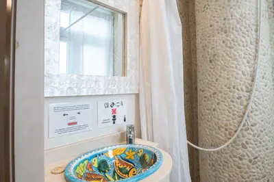 a bathroom with a sink and a window at Apartamento Sherezade y la ciudad de Cádiz in Cádiz