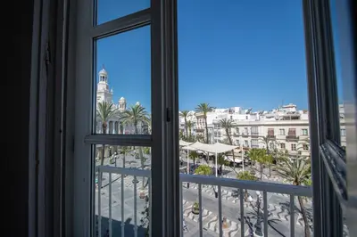 a window view of a city from a hotel room at Apartamento Sherezade y la ciudad de Cádiz in Cádiz